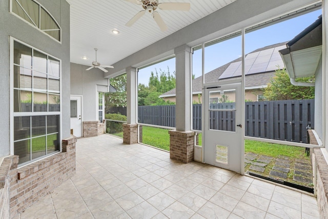 unfurnished sunroom with ceiling fan and wooden ceiling