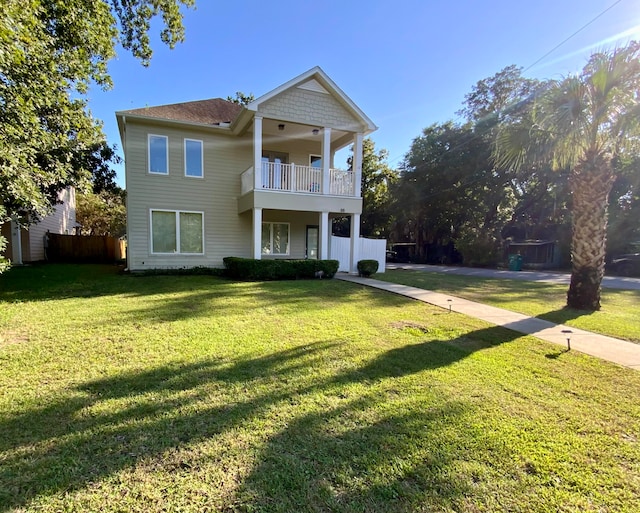 view of front of home with a front lawn and a balcony