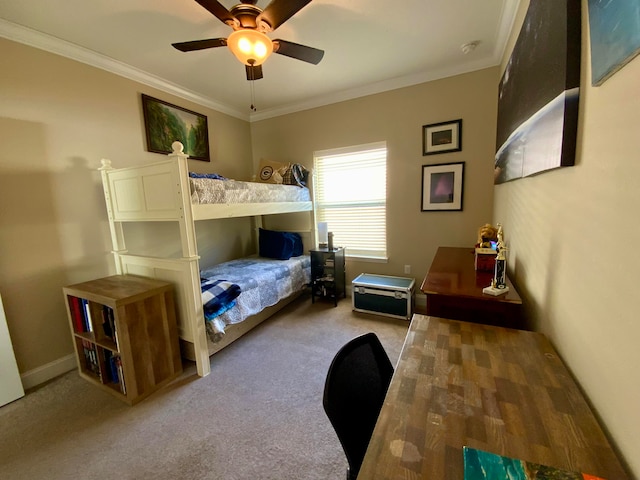 carpeted bedroom with ornamental molding and ceiling fan