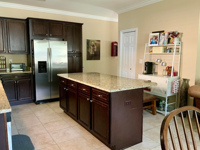 kitchen with a center island, stainless steel refrigerator with ice dispenser, dark brown cabinetry, crown molding, and light stone countertops