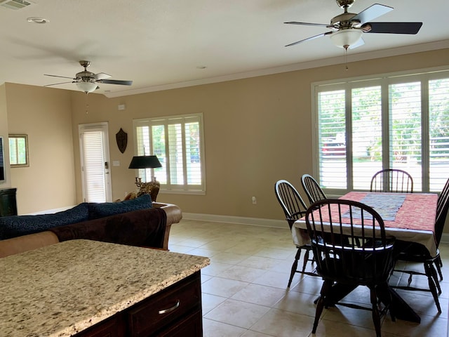 dining room featuring light tile patterned flooring, ceiling fan, a healthy amount of sunlight, and crown molding