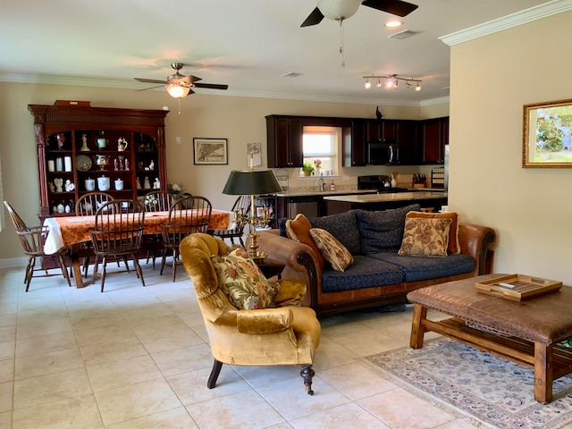 tiled living room with ornamental molding and ceiling fan