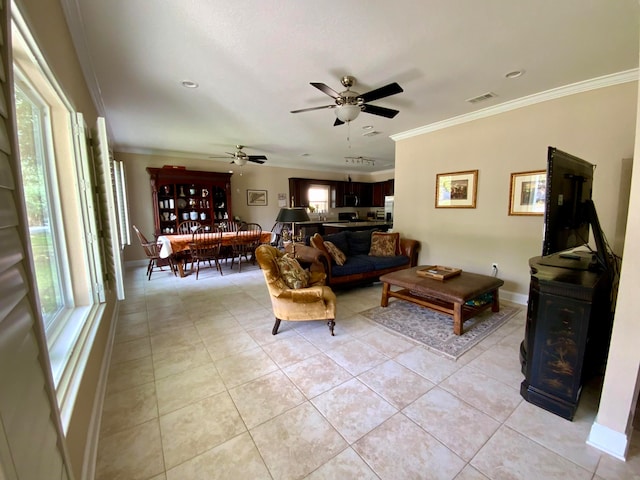 tiled living room with ceiling fan and crown molding