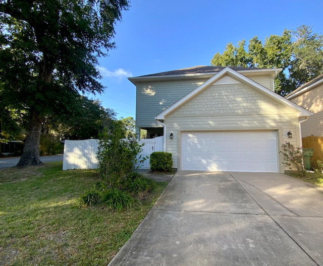 view of front of home with a garage and a front yard