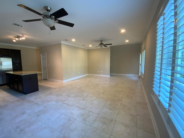 unfurnished living room with ceiling fan, crown molding, and light tile patterned floors