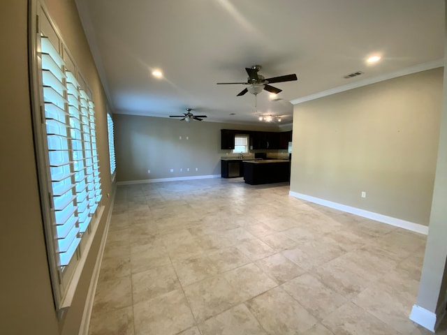 unfurnished living room featuring sink, ceiling fan, and crown molding