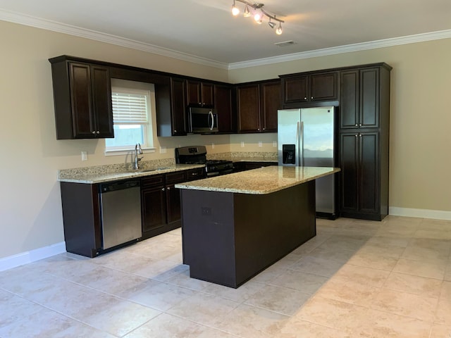 kitchen featuring light stone counters, crown molding, stainless steel appliances, dark brown cabinets, and a center island