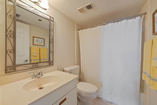 bathroom with vanity, a textured ceiling, toilet, and walk in shower