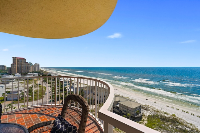 balcony featuring a water view and a view of the beach