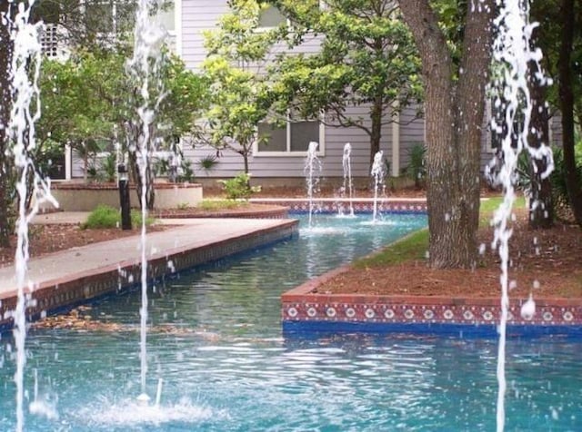 view of swimming pool featuring pool water feature