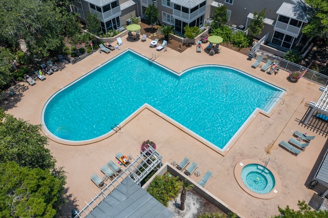 view of swimming pool featuring a hot tub and a patio