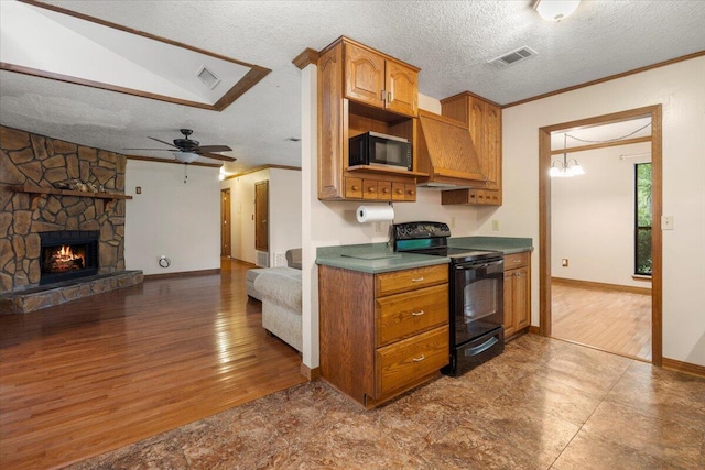 kitchen featuring a fireplace, ceiling fan with notable chandelier, a textured ceiling, light hardwood / wood-style flooring, and black appliances