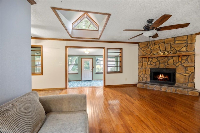 living room featuring a textured ceiling, wood-type flooring, and ceiling fan