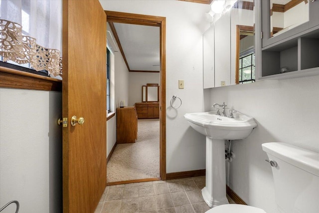 bathroom featuring crown molding, toilet, and tile patterned floors