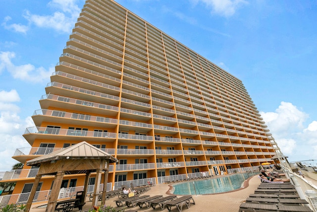 view of building exterior featuring a community pool