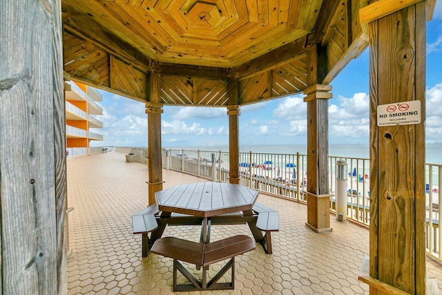 view of patio with a view of the beach and a water view