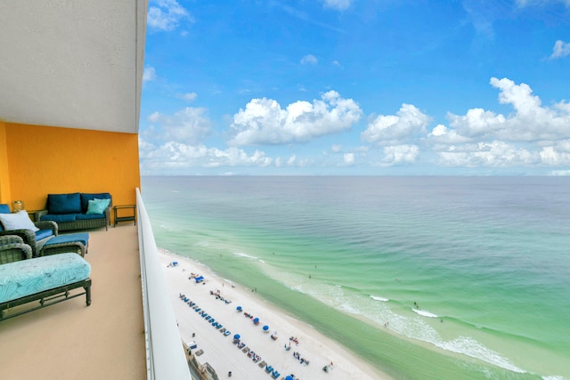 balcony featuring a water view and a beach view