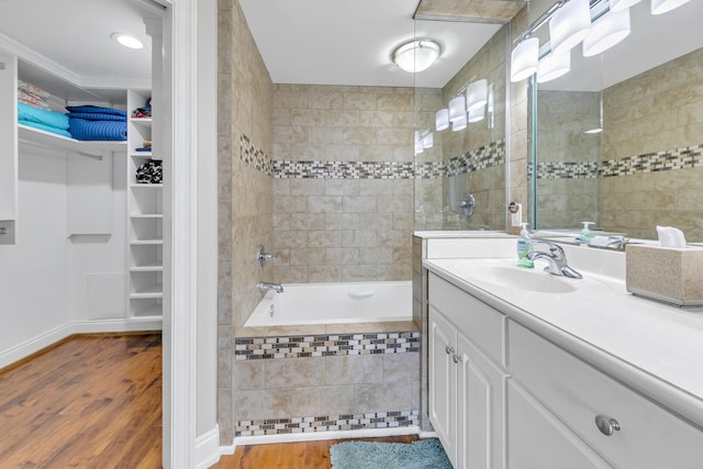 bathroom with vanity, hardwood / wood-style flooring, and shower with separate bathtub