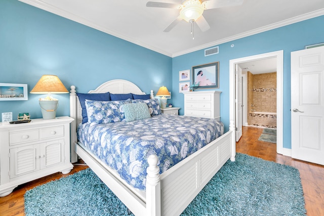 bedroom with ceiling fan, crown molding, connected bathroom, and wood-type flooring