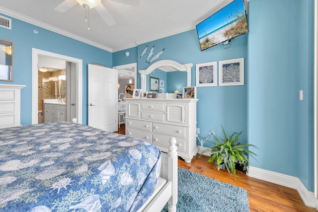 bedroom featuring hardwood / wood-style floors, ceiling fan, connected bathroom, and ornamental molding