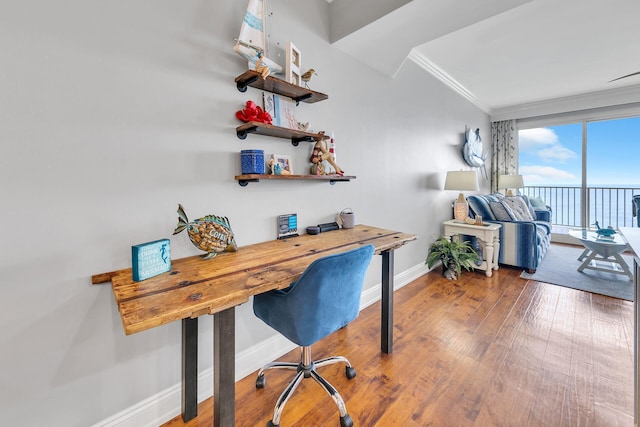 home office with crown molding and hardwood / wood-style floors