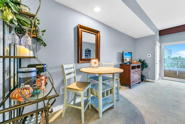 dining space featuring light colored carpet