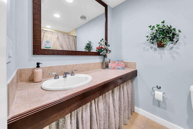 bathroom with tile patterned flooring and vanity