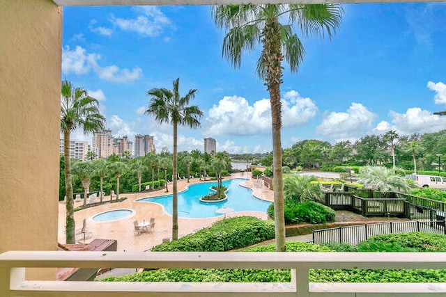 view of swimming pool with a patio area and a hot tub