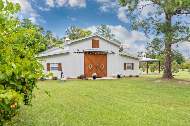 rear view of property featuring a yard