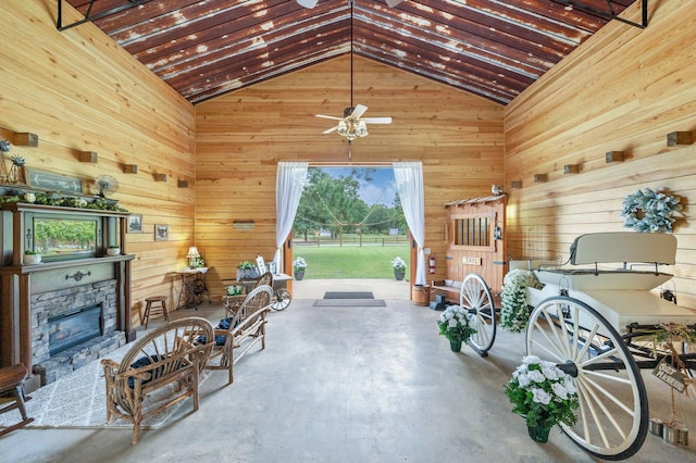 interior space with ceiling fan and wood walls