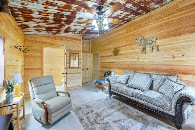 living room with lofted ceiling, wood walls, and ceiling fan