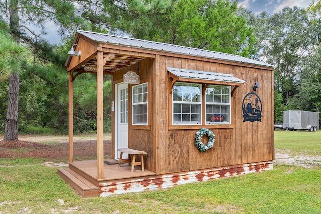 view of outbuilding featuring a yard and a gazebo