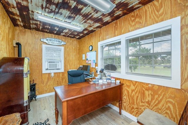 home office featuring light hardwood / wood-style flooring and wood walls