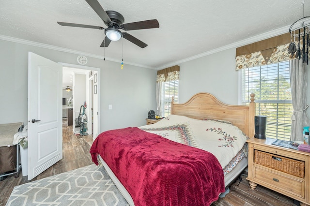 bedroom with dark wood-type flooring, ceiling fan, crown molding, and a textured ceiling