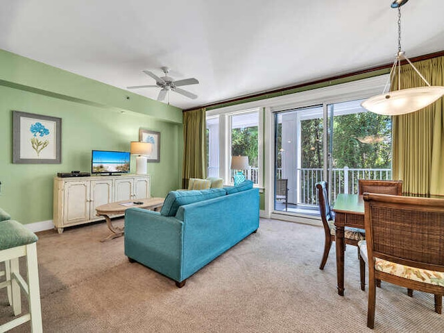 living room with ceiling fan and light colored carpet