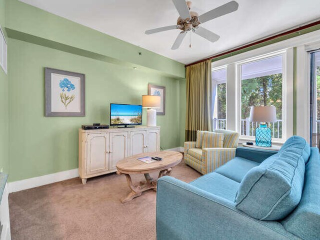 living room featuring light carpet and ceiling fan