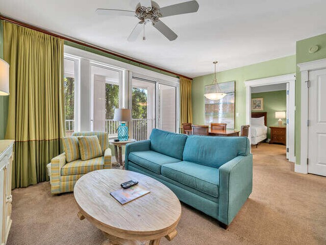 living room featuring light carpet and ceiling fan