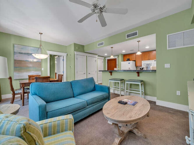 carpeted living room featuring ceiling fan