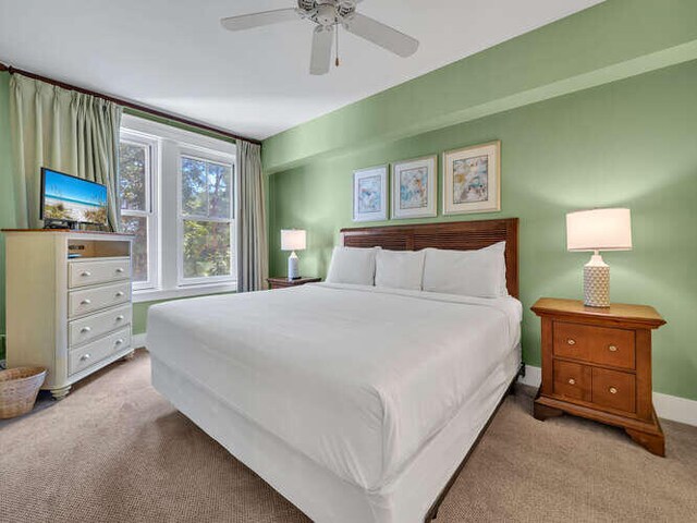 bedroom featuring light carpet and ceiling fan