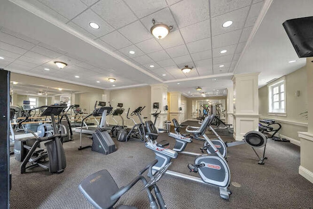 gym featuring crown molding and a drop ceiling