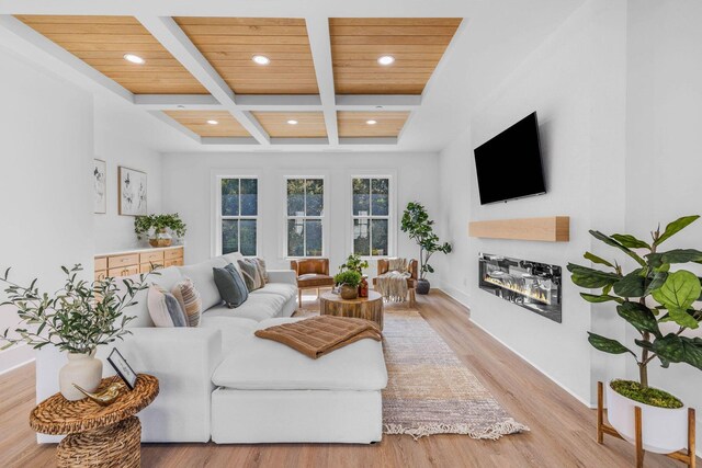 living room with coffered ceiling, light hardwood / wood-style flooring, beam ceiling, and wood ceiling