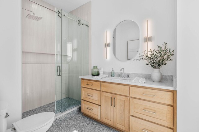 bathroom with vanity, toilet, and an enclosed shower