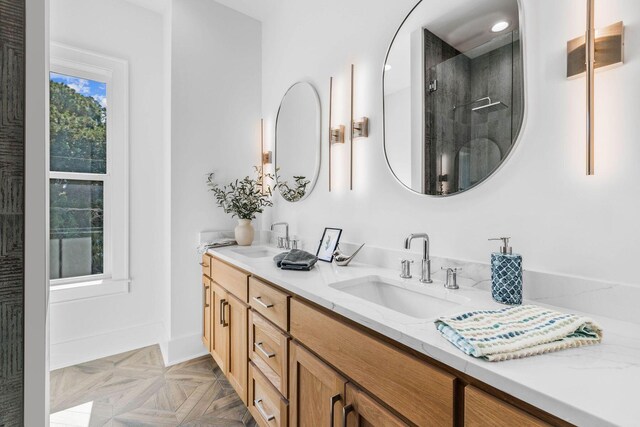 bathroom with vanity, parquet flooring, and a shower with shower door