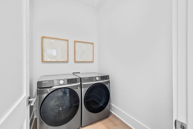 laundry area featuring light wood-type flooring and washer and dryer