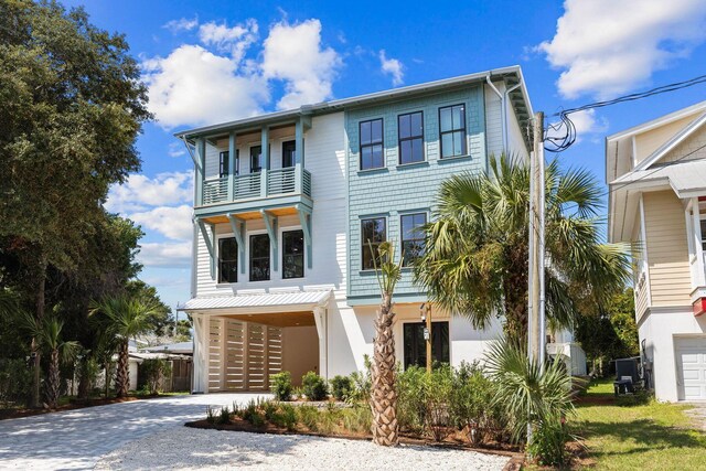 view of front of property with a balcony and a garage