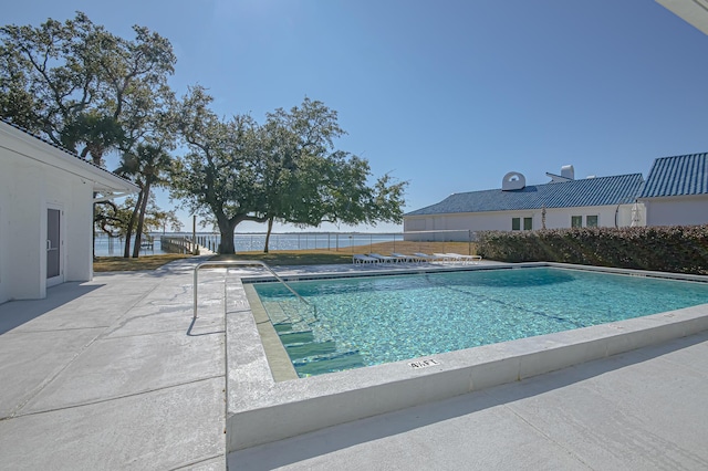 pool featuring a patio and fence