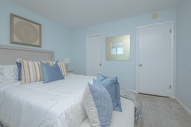 bedroom with baseboards and carpet flooring