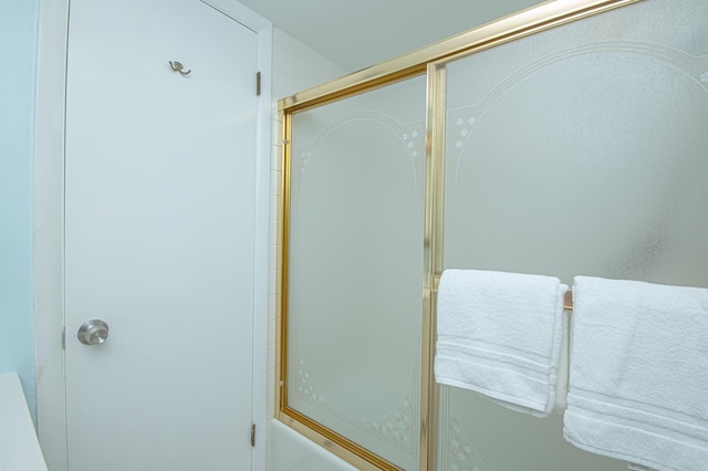 bathroom featuring a shower with shower door