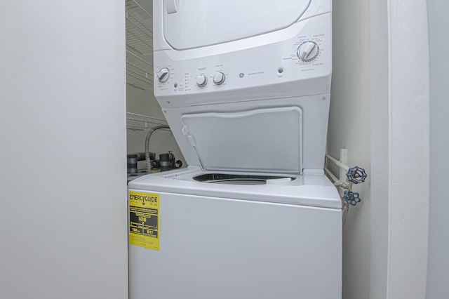 clothes washing area with laundry area and stacked washing maching and dryer