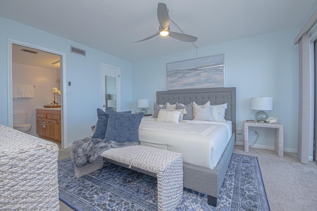 bedroom featuring baseboards, carpet, visible vents, and connected bathroom